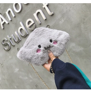 Detailed close-up of grey plush cloud bag featuring cute embroidered cat face and gold chain
