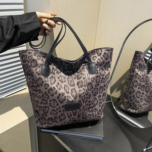 Classic leopard print tote bag with black leather straps in a stylish vintage aesthetic