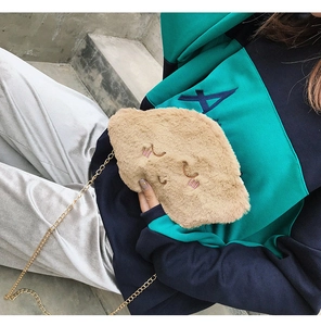 Detailed view of cloud-shaped plush shoulder bag with smiley face embroidery and gold chain