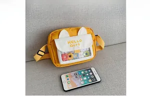 Size comparison of the yellow cat-ear shoulder bag next to a smartphone device