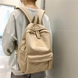 Minimalist beige Korean style backpack for students featuring a durable canvas design