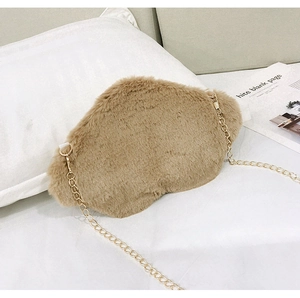 Detail view of a fluffy brown cloud-shaped plush bag with a slender gold metal chain strap