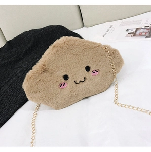 Close-up of brown plush toast bag with cute cartoon embroidery and gold chain strap