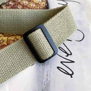 Detail of adjustable black buckle and premium green nylon strap for crossbody bag