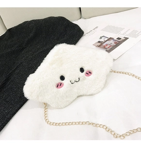 Close-up of fluffy white cloud plush bag featuring embroidered face and gold chain strap