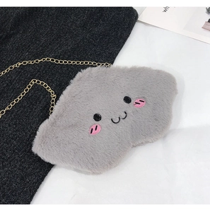 Detail of grey plush cloud-shaped bag with cute facial expression and golden chain