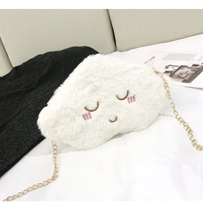 Macro detail of plush cloud bag featuring closed-eye smiling embroidery and gold chain