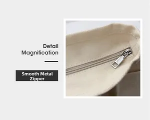 Detailed close-up of the smooth metal zipper on this high-quality canvas tote bag