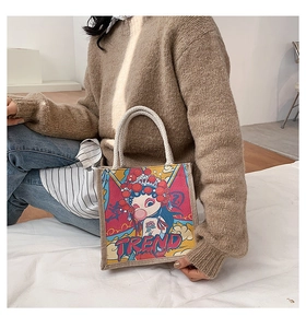 Detail of canvas tote bag with cartoon opera illustration and thick rope handles
