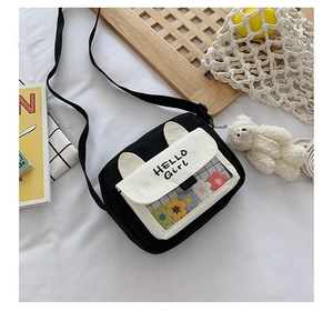 Close-up of cute cat-ear canvas crossbody bag with transparent window and colorful flowers