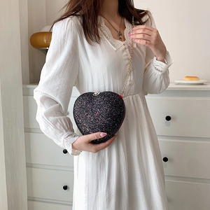 Sparkling heart-shaped crossbody evening bag with black sequins and gold chain strap