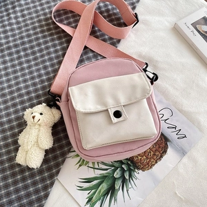 Pink and beige nylon canvas crossbody bag with adjustable strap and cute bear charm