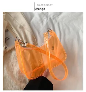 Detail view of transparent orange PVC shoulder bag with silver zipper and metallic hooks