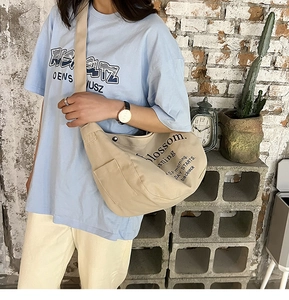 Detail of canvas tote bag showing magnetic snap closure and blossom morning text design