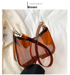 Detailed view of brown transparent PVC shoulder bag with silver hardware and black zipper