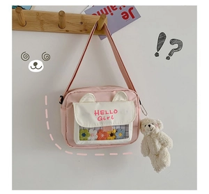 Pink and white crossbody bag with HELLO Girl print and cute plush bear keychain charm