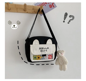 Detail of canvas crossbody bag featuring 3D ears, HELLO GIRL text and a plush bear