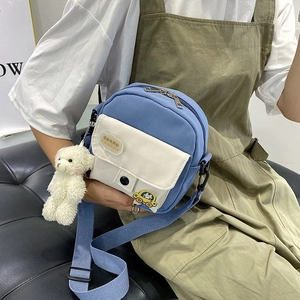Mini nylon crossbody bag with cute teddy bear charm and cartoon patch detail
