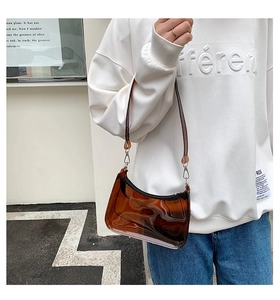 Side view of an amber transparent PVC jelly bag shown on model for style display