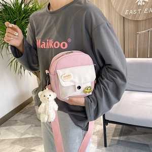 Pink and white canvas crossbody bag with BREAD patch and cute plush bear charm detail