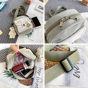Detail view of the mini canvas bag showing its internal capacity and zip closure