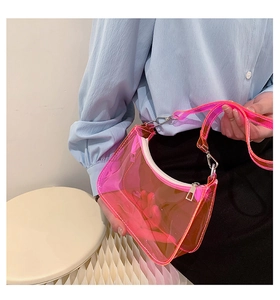 Detailed close-up of a pink transparent PVC shoulder bag with silver zipper and stitching