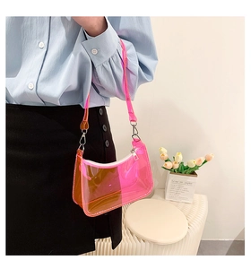 Detail of neon pink gradient PVC shoulder bag with silver zipper on a fashion model