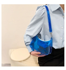 Blue transparent PVC shoulder bag styled with a minimalist outfit for a trendy look
