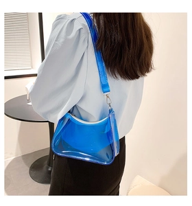 Detailed view of transparent blue PVC baguette bag with silver hardware and shoulder strap