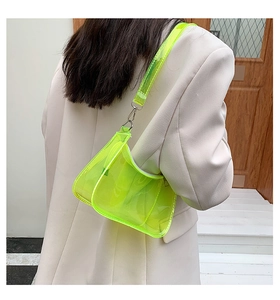 Neon yellow transparent PVC hobo bag shown on model with sleek metallic buckles