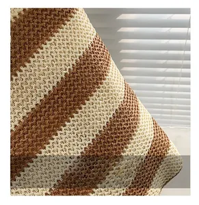 Close-up of dual-tone straw woven tote bag showing tight textures and striped pattern
