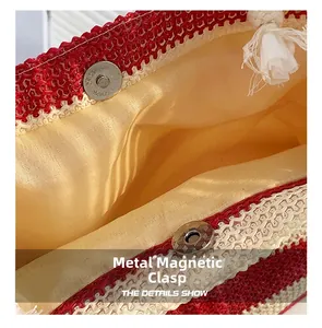 Detail of metal magnetic buckle and interior lining on a woven straw tote bag