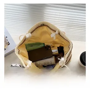 Straw tote bag interior showing large capacity with yellow lining and magnetic buckle