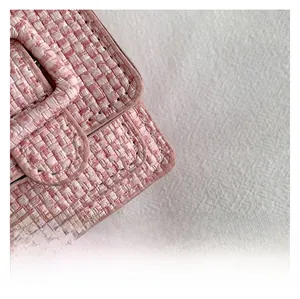 Détail macro du mini sac en tweed rose montrant la texture tissée et les bords en cuir