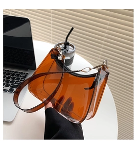 Detailed view of the amber brown translucent PVC material and zipper on this baguette bag