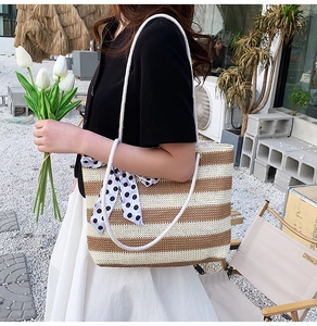Detail of striped woven tote bag with rope handle and polka dot scarf accessory