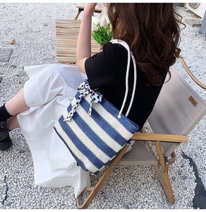 French style blue and white striped straw tote bag with rope handle and polka dot bow
