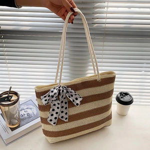 Large straw tote bag with brown stripes and polka dot bow for summer vacation