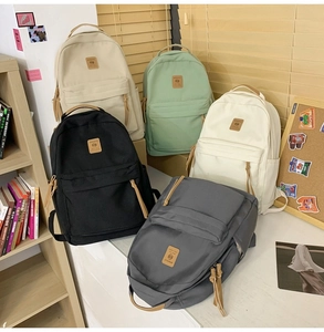 Detail shot of five color options for this minimalist nylon student school backpack