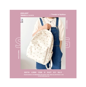Detail view of floral canvas backpack with front zipper pocket and side mesh storage pouch