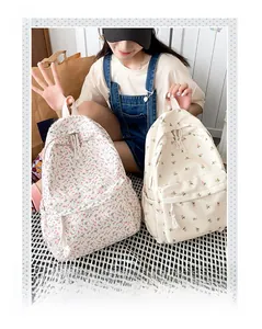 Detail of floral canvas backpacks featuring tassel zippers and convenient side pockets