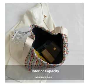 Detail showing the large internal capacity of the colorful woven tote bag with a folding umbrella