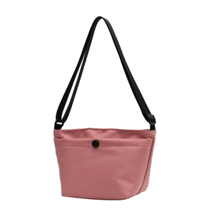 Minimalist light pink crossbody shoulder bag with black strap and round buckle detail