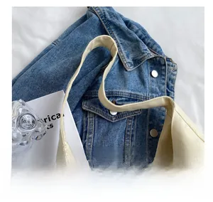 Close-up of durable canvas tote bag texture with reinforced stitching and wide straps