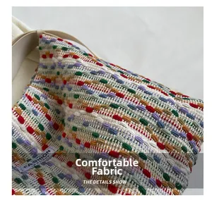 Close-up of multicolor woven fabric texture with Fashion Instinct label on tote bag
