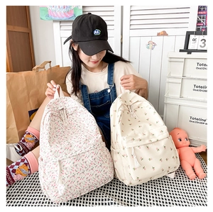 Detail of floral Japanese style backpacks with drawstring closure and front zipper pocket