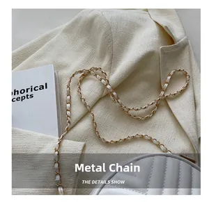 Close-up of elegant quilted shoulder bag showing premium hardware chain strap detail