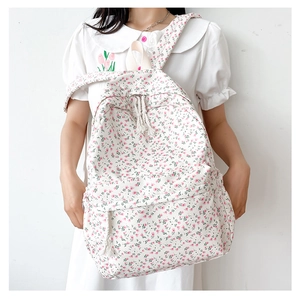 Floral canvas backpack for girls with pink flower pattern shown in a top-down view