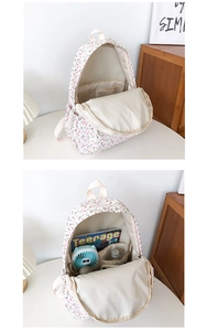 Detail view of the floral backpack interior with multiple compartments for B5 books