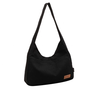 Minimalist black large capacity canvas tote bag with side pocket and sport leather label